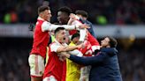 Soccer-Arsenal seal thrilling comeback win, Man City maintain chase