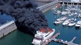 Blaze which destroyed £6m superyacht leaves gin and cushions floating in harbour