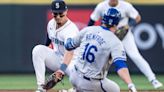 ...second baseman Josh Rojas, left, the tags out the Kansas City Royals' Hunter Renfroe, who was attempting to stretch a single into a double in the third inning at T-Mobile Park...