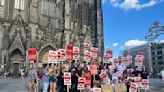 “We Are Today… WGA!” German Writers Show Strike Solidarity At Cologne Cathedral Protest
