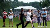 Six protesters run onto 18th green and spray powder, delaying finish of Travelers Championship