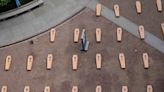 Mock coffins fill a square in Milan in a protest over workplace safety in Italy