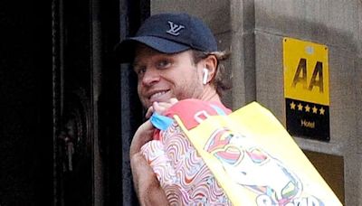 Olly Murs is all smiles as he FINALLY arrives in Glasgow after he was forced to cancel his concert with Take That