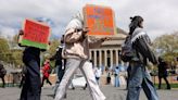 Columbia University student in handcuffs rips up diploma on commencement stage in act of protest