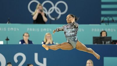 Simone Biles tweaks left ankle at Olympic qualifying, but keeps competing