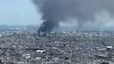 Tourist standing at top of Eiffel Tower captures smoke billowing from Paris fire