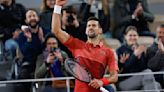 Novak Djokovic keeps his French Open title defense going by getting past Lorenzo Musetti in 5 sets
