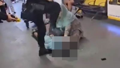 Moment armed policeman stamps on suspect's head during violent arrest