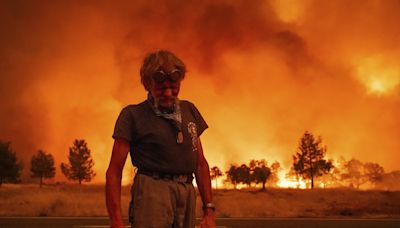 Firefighters helped by cooler weather battle blaze that has scorched area larger than Los Angeles