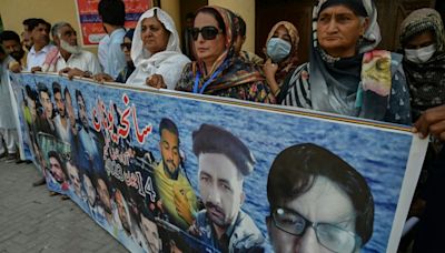 A year after migrant shipwreck, bereaved determined to leave Pakistan