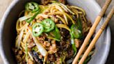 Thinly sliced fried scallions add bold flavor to savory pork noodles