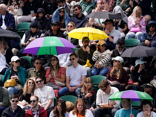 Heavy downpours suspend play on outdoor courts at Wimbledon