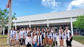 14 sets of twins and one set of triplets graduate from the same high school class