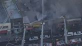 Large fire in the Bronx engulfs row of stores