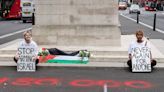 Activists lay Palestine flag on London's cenotaph and spray-paint