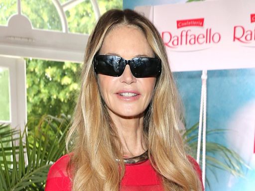 Elle Macpherson stuns in a slinky red gown as she steps out in Berlin