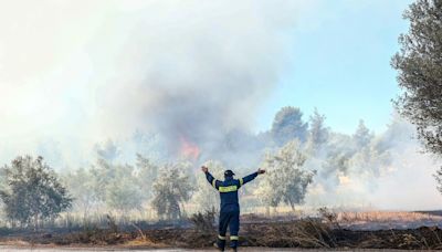 Athens suburbs on fire as Greece calls on EU for help