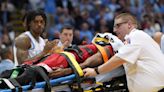 NC State's Terquavion Smith taken off court on stretcher after hard foul by UNC's Leaky Black