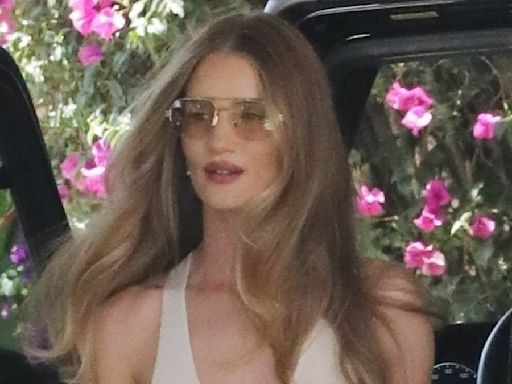Rosie Huntington-Whiteley goes braless in a nude vest and trousers