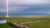 Lightning bolt strikes in sea off Dorset coast amid heavy rain and thunderstorms