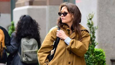 Katie Holmes’s Mustard Brown Trench Is the Perfect Coat for Waiting Out Summer