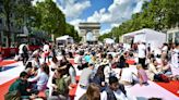 Paris hosted a giant picnic for over 4,000 people on the iconic Champs-Élysées as it tries to attract local customers ahead of the Olympics