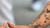 An inmate voting in Mexico's presidential election has his thumb inked at a jail in Puente Grande, Jalisco state