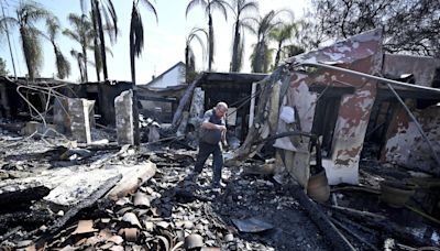 Wildfires plague the West amid a scorching heat wave. Homes burn in Southern California