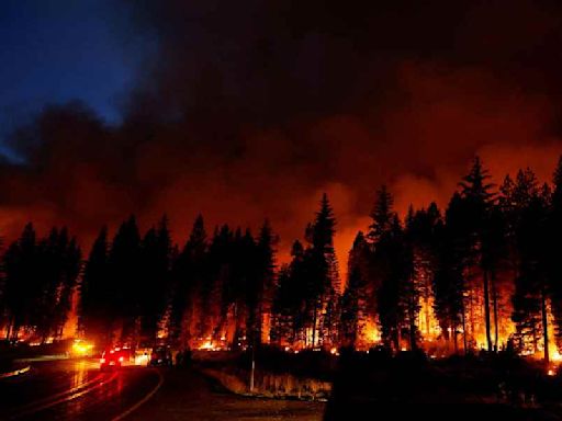 Firefighters battle California’s seventh largest wildfire on record as thousands under threat