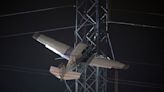 Crews work to rescue 2 in plane caught high in power lines