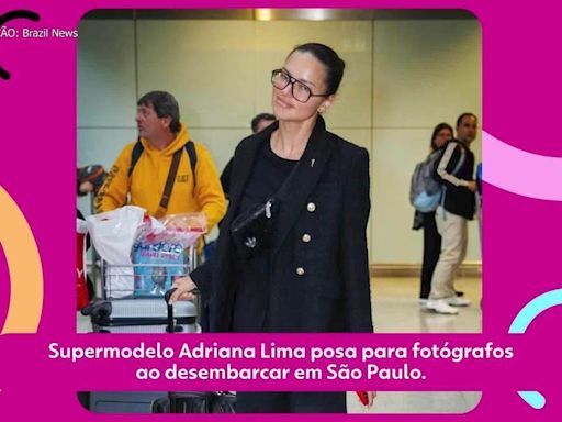 Supermodelo Adriana Lima posa para fotógrafos ao desembarcar em São Paulo