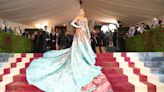 Blake Lively hops over rope at Kensington Palace exhibit to fix her displayed Met Gala dress
