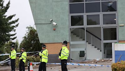 Police guard damaged Holiday Inn Express in Tamworth day after riots