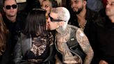 Kourtney Kardashian and Travis Barker Do Their Trademark Tongue Kiss Front Row at Her Boohoo Show