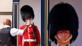 Photos show the Queen's guards wearing traditional long-sleeved uniforms and woolly bearskin hats amid extreme heatwave