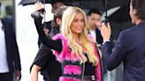 Paris Hilton Braves the Rain in a Hot Pink Moto Vest and Miniskirt — and More from Paris Fashion Week