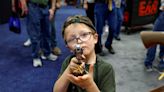 Photos show kids as young as 6 handling guns at the NRA's annual meeting. Guns are the leading cause of death among US children.