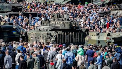 Russians descend on Moscow's Victory Park to goggle at captured Western military hardware including British armoured cars put on display by Putin after they were seized in Ukraine