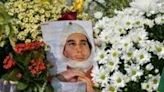 National hero: People lay flowers at the grave of Ayrton Senna in Sao Paulo