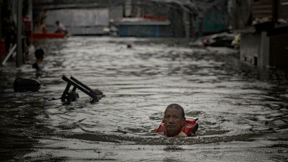 Thousands stranded by floods in Philippine capital as deadly typhoon prompts calls for climate action