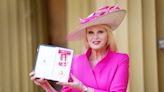Joanna Lumley Matches Her Hot Pink Outfit to Her Damehood Medal in Ceremony with Princess Anne