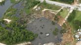 Alarming video shows 1,050ft sink hole swallowing cars and telephone poles as it continues to grow