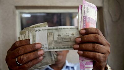 Rupee slips to record low as equity sentiment sours after tax hike