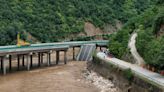 11 dead and dozens missing after a highway bridge in China crumbles in flooding and heavy storms