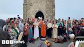 Hundreds gather to watch summer solstice sunrise at Glastonbury Tor