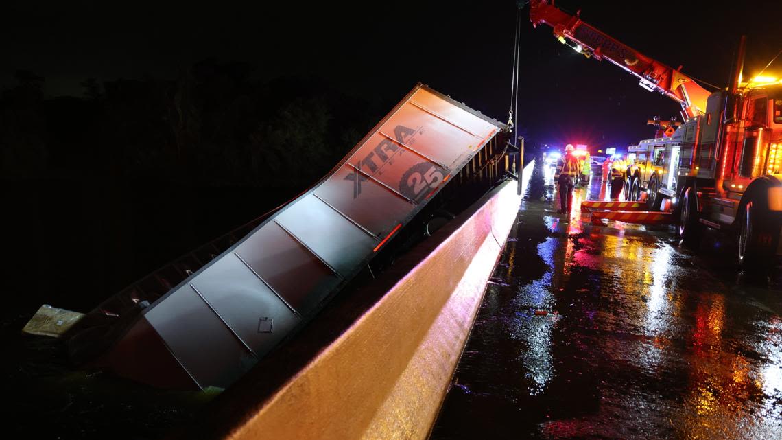 Semi-truck half submerged in the Tampa Bypass Canal after veering off I-75