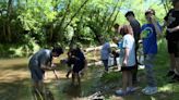 Janus School students release record amount of trout into stream