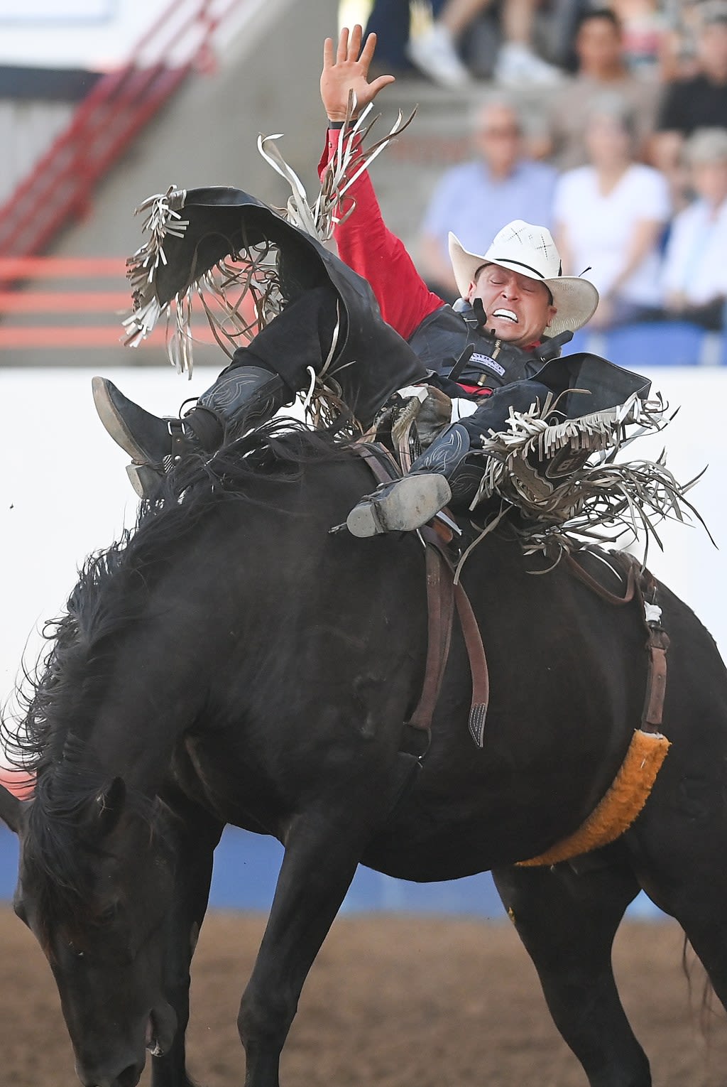 Dalton Sanchez drives his way to a top bull riding score at the Greeley Stampede rodeo