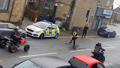 Dramatic moment police officer is struck by a quad bike