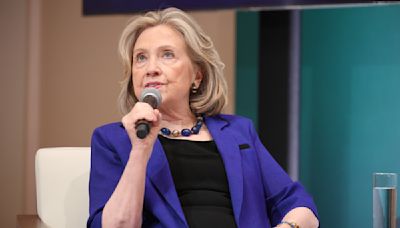 Hillary Clinton Embraces Statement Suiting With Vibrant Purple Blazer and Accessories at Vital Voices Global Festival 2024